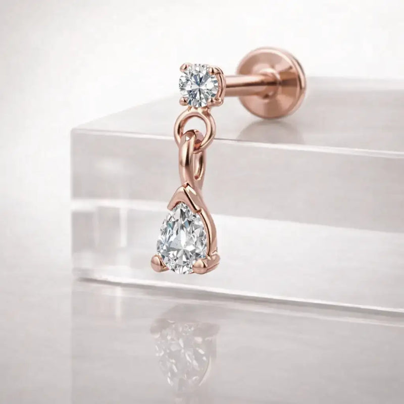 14k rose gold diamond pear drop flat back labret on acrylic block, angled view showing dainty size