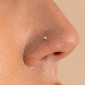 1.5mm princess-cut diamond nose stud shown in pierced nostril, close-up fit view