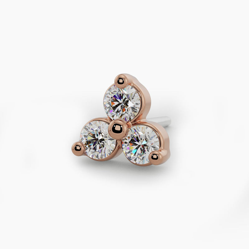 Close-up overhead view of 14k rose gold trinity diamond nose stud end showing warm gold setting detail