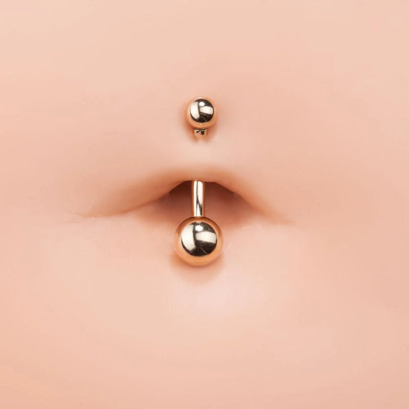 14k yellow gold double ball belly ring shown in navel piercing for fit and size reference