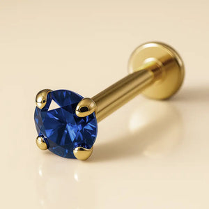 2mm blue sapphire 14k yellow gold prong-set flat back labret, angled view showing disc backing