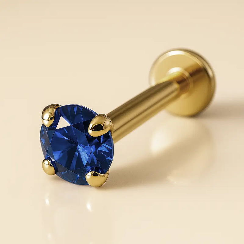 2mm blue sapphire 14k yellow gold prong-set flat back labret, angled view showing disc backing
