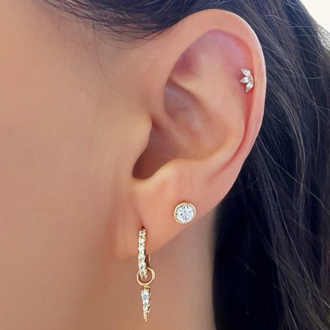 Marquise lotus stud end shown in a model's helix piercing alongside gold lobe jewelry