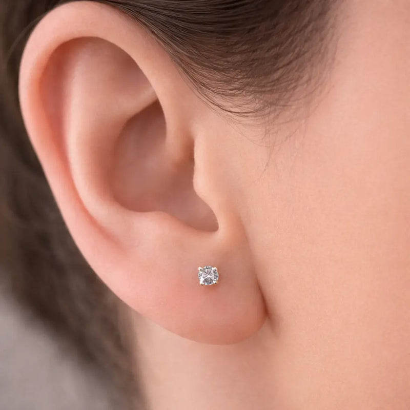 3.5mm diamond prong-set flat back labret stud worn in earlobe piercing for fit reference