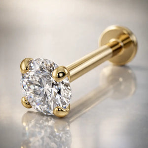 14k yellow gold 3.5mm diamond flat back labret on reflective surface, angled lifestyle shot