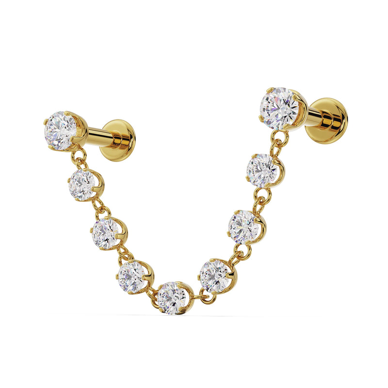 14K yellow gold Lyra connector labret studs showing flat back posts and nine-CZ swag chain, angled view