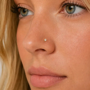 Close-up of a woman's face with a diamond nose ring.