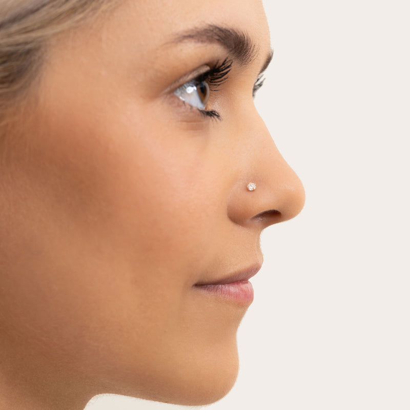 Pure side profile of 3mm diamond prong nose stud in pierced nostril, showing low-profile setting fit