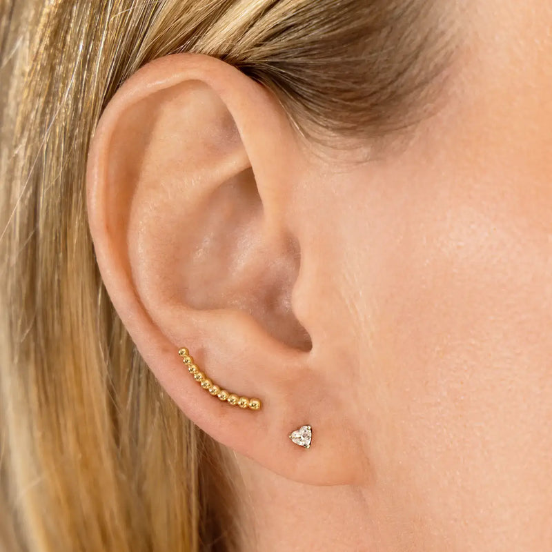 3mm heart diamond flat back stud worn in lobe piercing, styled in gold ear stack with bar climber