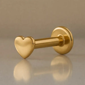 14k yellow gold tiny heart flat back labret showing polished heart charm and 3mm disc backing, angled view