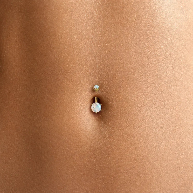 Close-up of the Astra moonstone belly button ring on a model's navel piercing