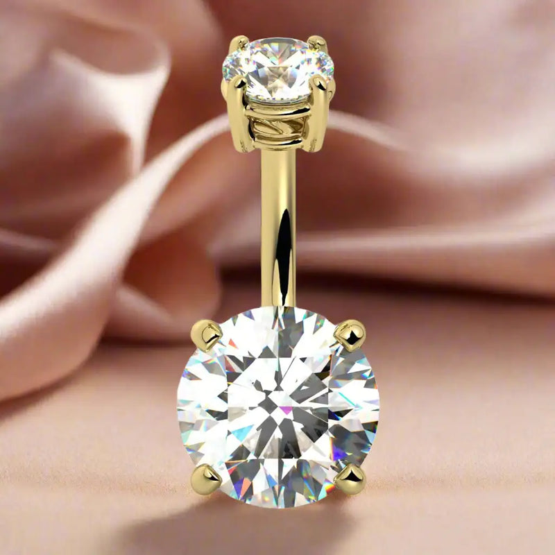 14k yellow gold diamond belly ring front view against soft satin fabric background
