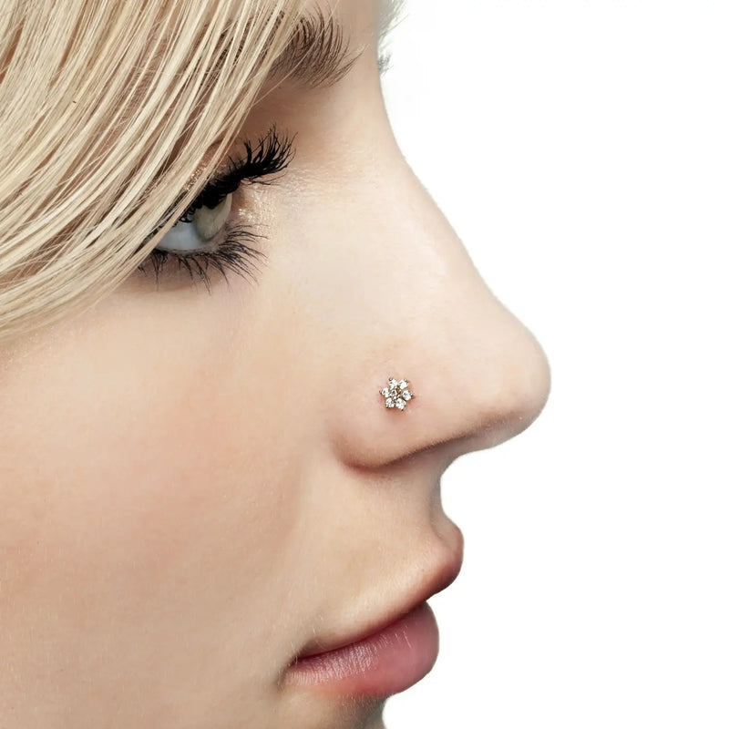 Clear CZ flower 14K gold nose ring twist worn in pierced nostril, side profile model shot for fit