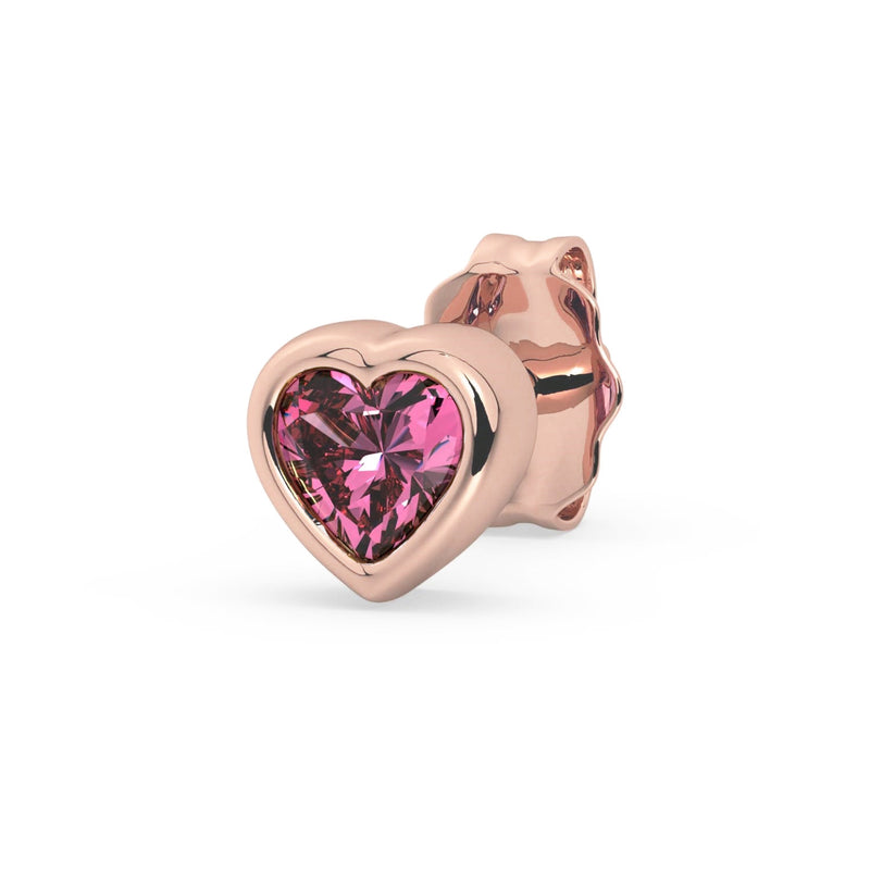 Single 14k rose gold pink sapphire heart stud earring, angled view with vibrant pink stone in rose gold