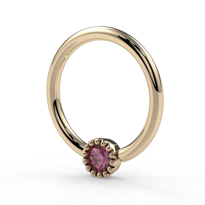 Angled side view of 14k yellow gold pink diamond milgrain captive bead ring showing hoop depth