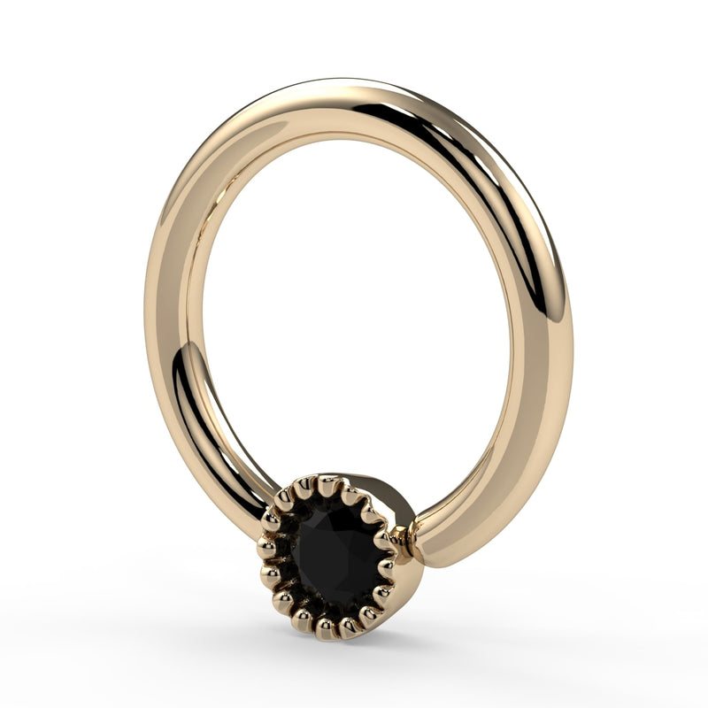 14k yellow gold black diamond Perlagé captive ring, three-quarter angled view showing ring thickness and bead charm