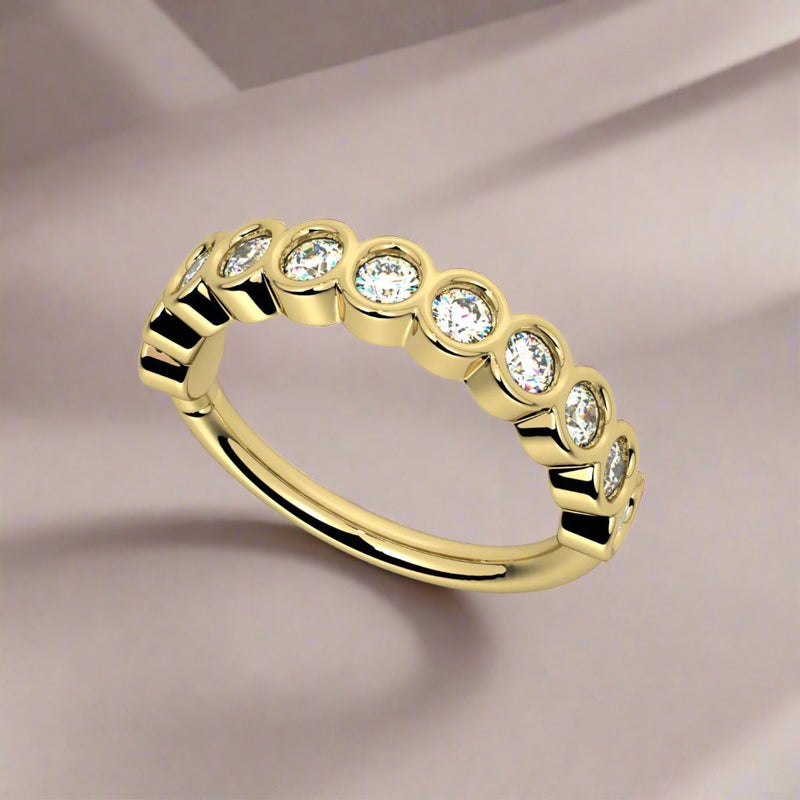 14k yellow gold CZ bubbles seam ring on draped fabric background, angled lifestyle shot