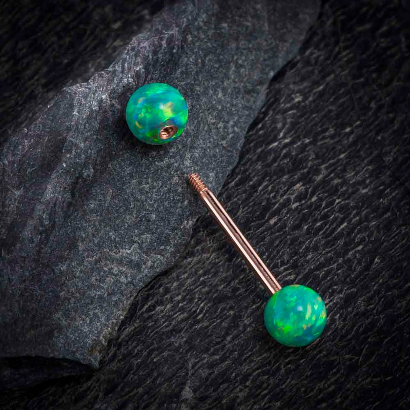 14k rose gold teal opal straight barbell disassembled on dark stone, showing internally threaded post
