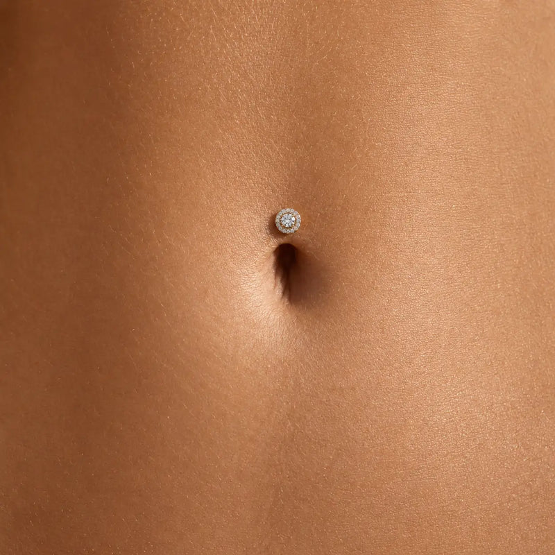 Diamond halo floating belly ring shown in navel piercing on model for fit and scale