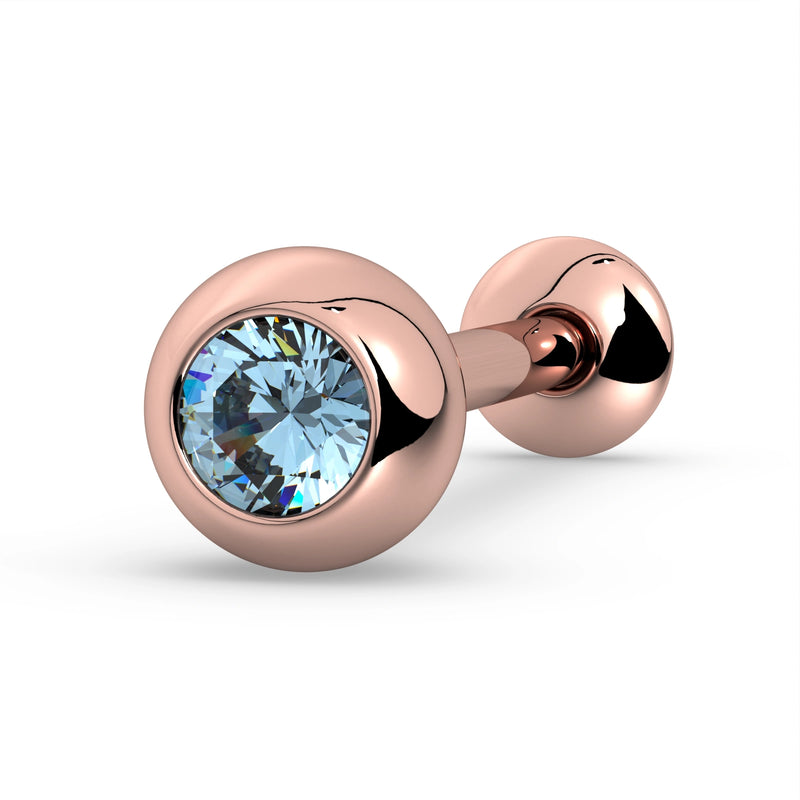 14K rose gold tongue barbell with aquamarine gemstone in bezel setting, warm-toned angled view