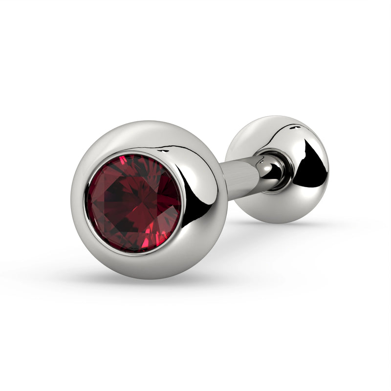 14K white gold tongue barbell with ruby gemstone in solid bezel ball, angled view on white background