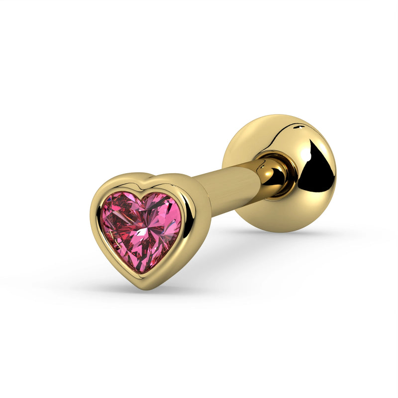 14k yellow gold tongue ring with bezel-set heart-cut pink sapphire, angled view highlighting gem color