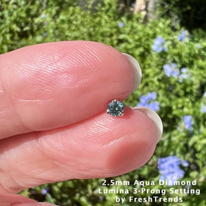 2.5mm genuine aqua diamond held between fingertips outdoors for stone size reference