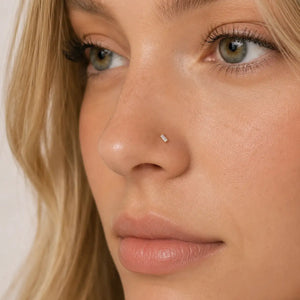 Close-up of a woman's face wearing a baguette nose ring.