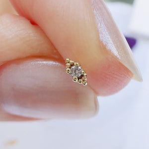 14k yellow gold diamond beaded piercing stud end held between fingers for size reference