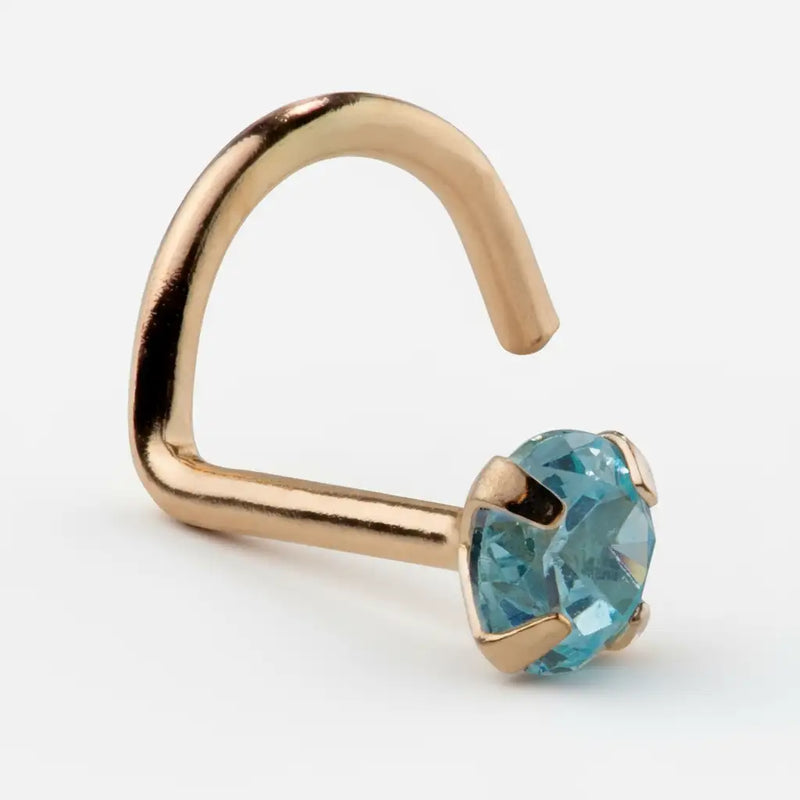14K rose gold twist nose ring with genuine blue zircon in four-prong setting, angled side view