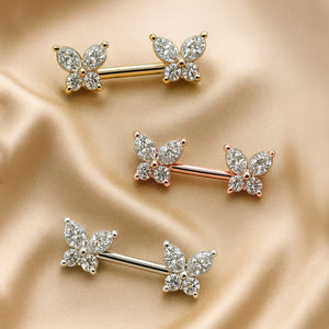 14k yellow gold, rose gold, and white gold butterfly nipple barbells shown together on satin fabric
