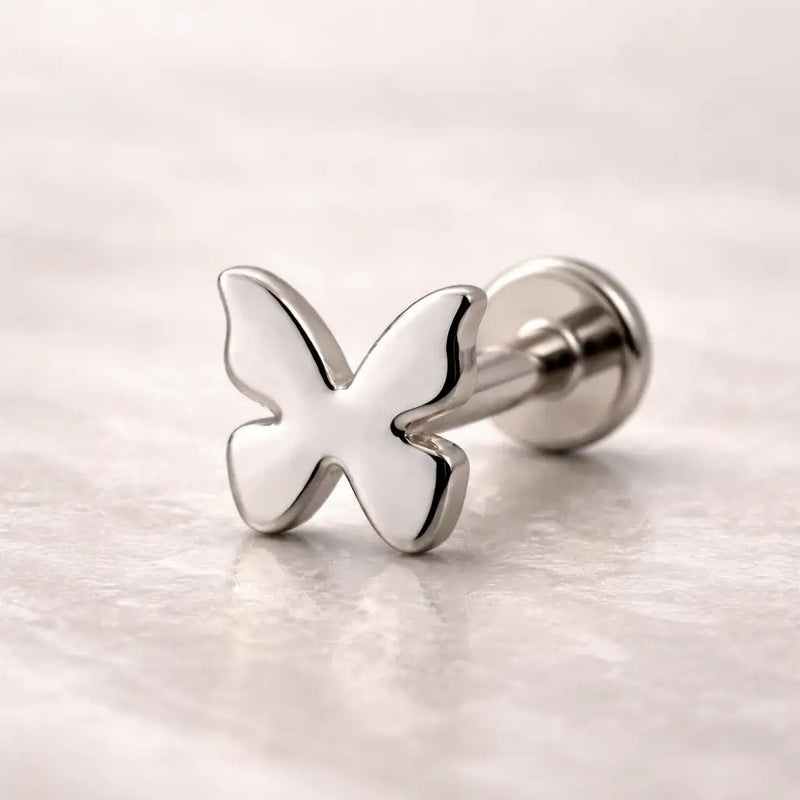 14k white gold butterfly flat back labret stud with post and flat disc backing on marble surface
