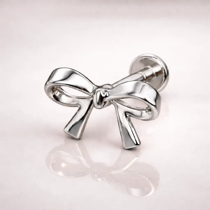 14k white gold classic bow flat back stud, side-angled view showing polished finish and labret post