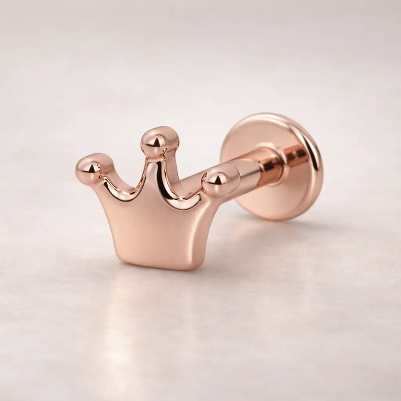 14k rose gold crown flat back labret stud, angled view showing warm pink-gold polished crown charm