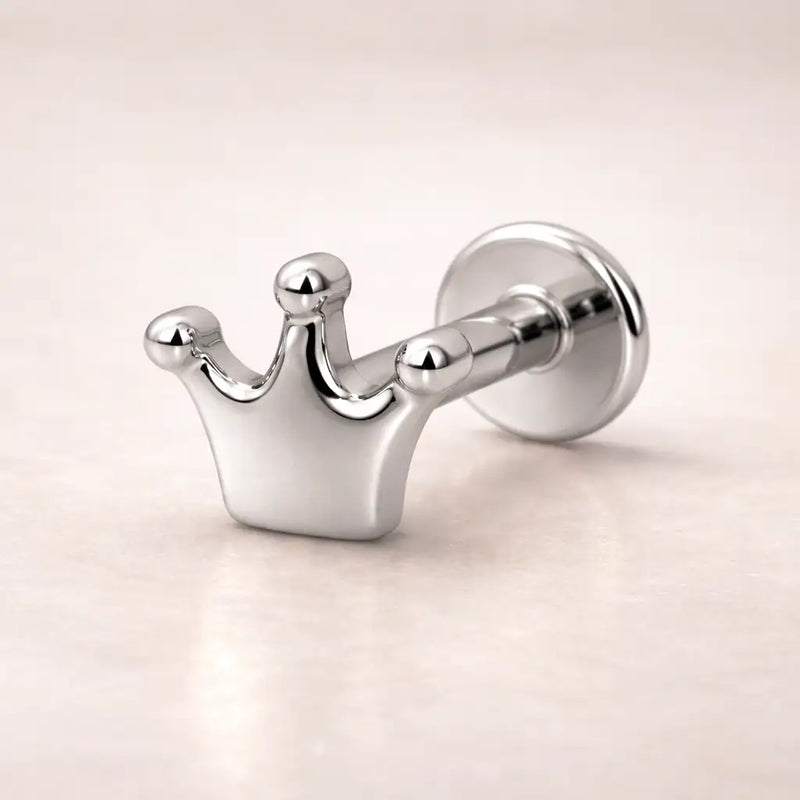 14k white gold crown flat back labret stud, angled view highlighting polished silver-tone finish