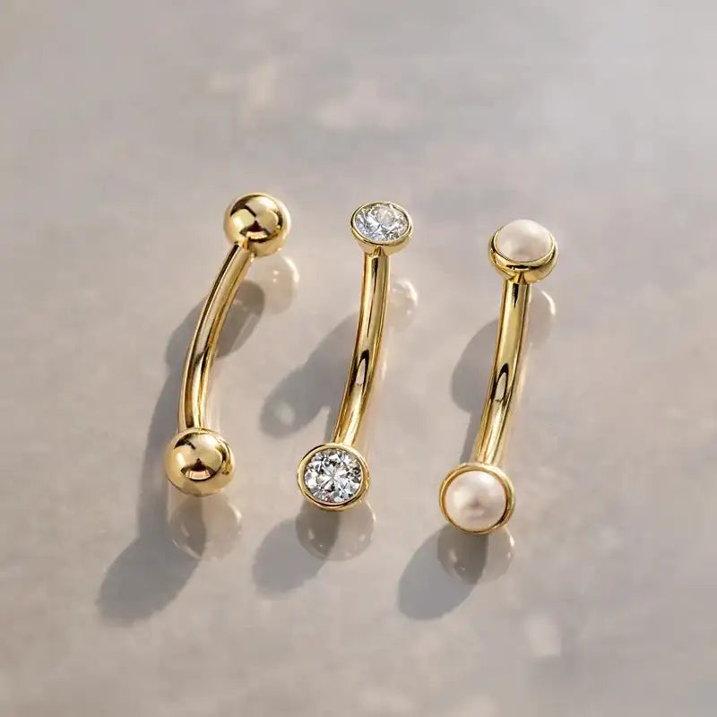 Three gold curved barbells