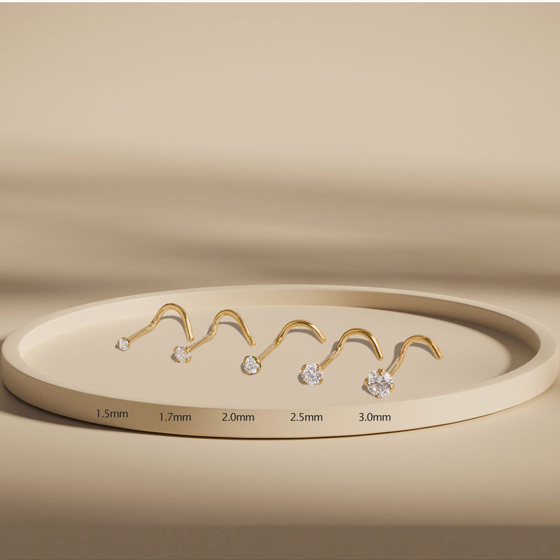 14k gold diamond nose studs in five sizes from 1.5mm to 3mm displayed on beige tray for comparison