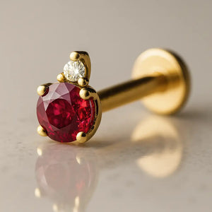 14k yellow gold ruby and diamond accent flat back labret, angled view showing prong setting and flat disc