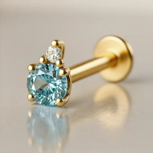14k yellow gold aquamarine and diamond accent flat back labret, angled view showing prong setting