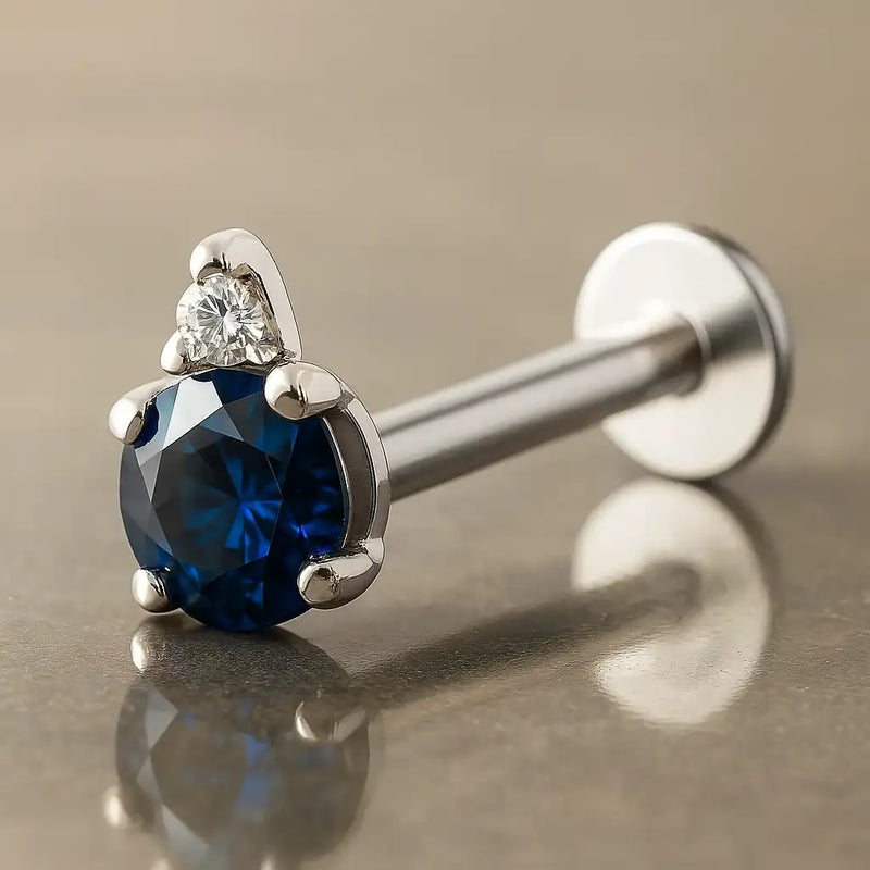 14k white gold flat back labret with round blue sapphire and diamond accent, angled side view
