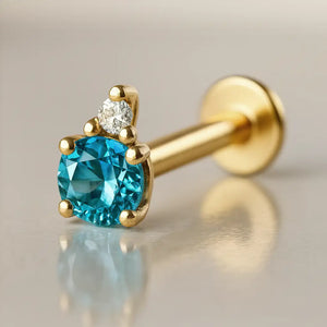 14k yellow gold blue topaz and diamond flat back labret, angled view showing prong setting and flat disc