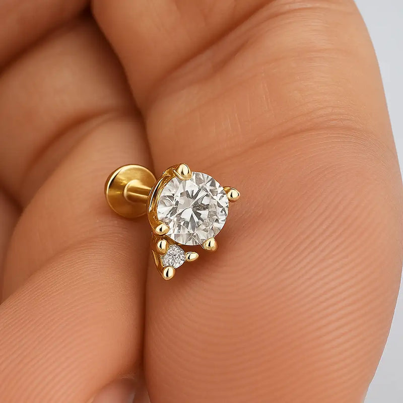 14k yellow gold diamond accent flat back labret held in palm for size reference, clear stone variant