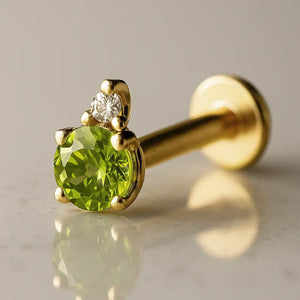 14k yellow gold peridot and diamond flat back labret, angled view showing prong setting and flat disc