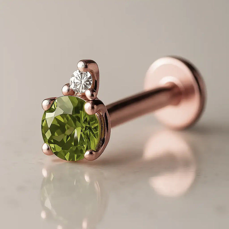 14k rose gold peridot and diamond flat back labret, angled view showing warm-toned prong setting