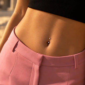 Model wearing a 3mm prong-set curved barbell in 14k gold in a belly button piercing