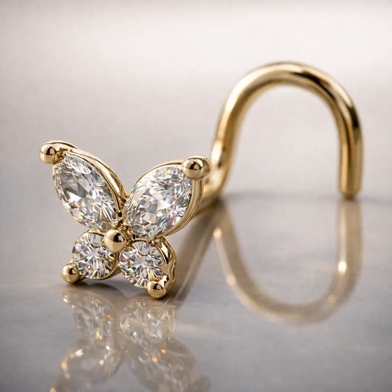 14k yellow gold diamond butterfly nose ring with twist backing on reflective surface