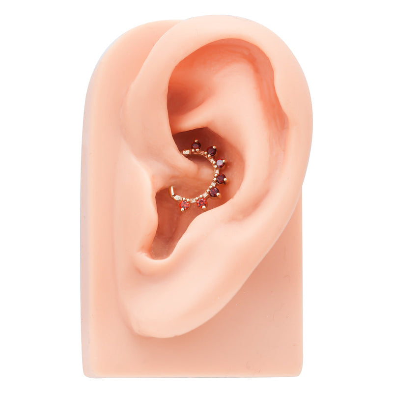 Rose gold CZ petal clicker ring shown in daith piercing on silicone ear model for fit reference