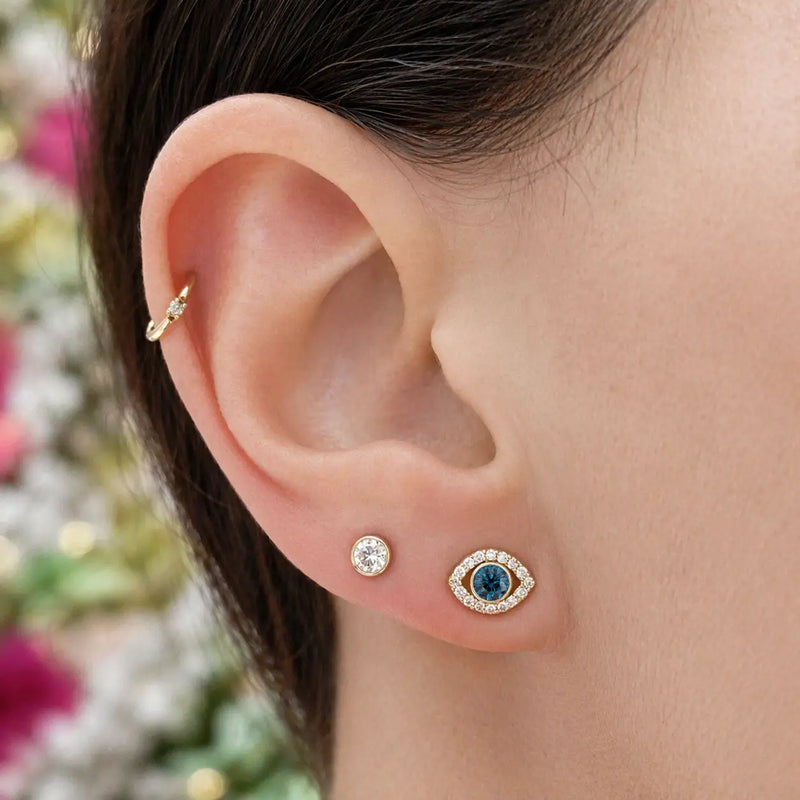 3.5mm diamond bezel flat back stud worn in lobe piercing, styled in a gold ear stack