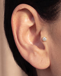 Diamond flat back stud worn in a tragus piercing