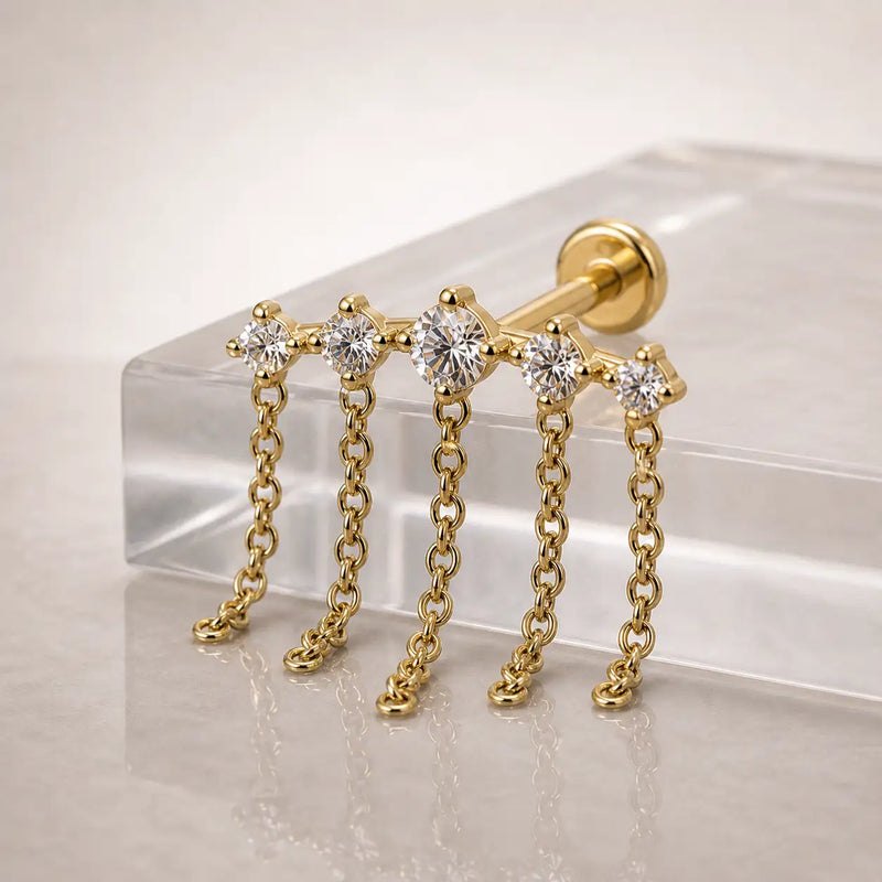 Evenfall flat back stud earring Dangling off a pedestal lifestyle photograph.
